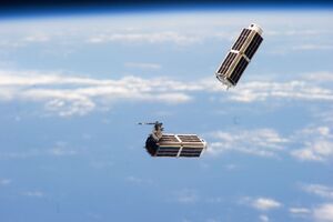 Doves launched from ISS float against Earth horizon.jpg