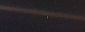 The earth a pale blue dot suspended in a sunbeam.jpg